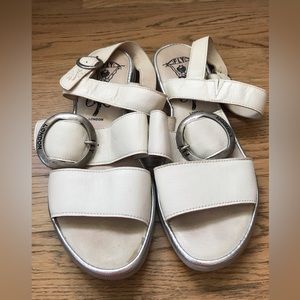Fly London bone colored flat sandals with silver colored hardware. Size 40.